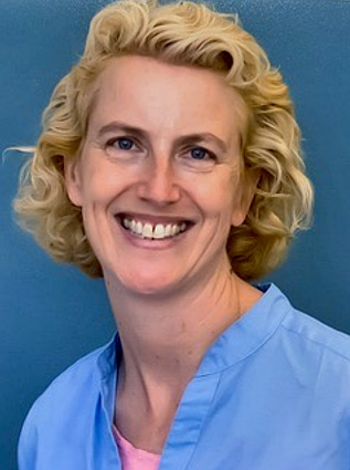 Mary Dolan wearing blue shirt with blonde hair